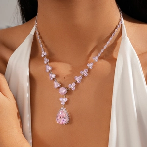 Detail of pink zircon flower necklace with a large teardrop pendant on a model
