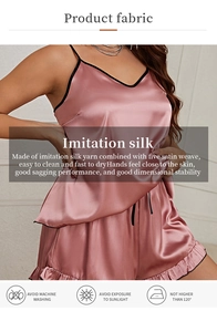 Detailed view of pink silk pajamas with black trim and fabric care instructions