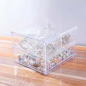 Close-up of dual-layer transparent acrylic storage box with beads and metal parts
