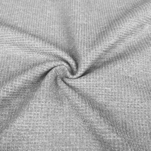 Close-up of gray waffle knit fabric texture showing high-quality softness and detail