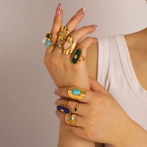 Gold plated stainless steel rings set with colorful natural stones worn by model