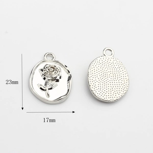 Macro detail of silver rose oval charm with dimensions 17mm by 23mm for DIY jewelry