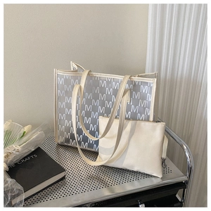 Detail view of large transparent tote bag with white letter print and inner pouch