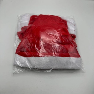 Detailed view of a plush red and white Christmas hat packaged in a clear plastic bag