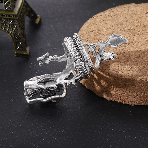 Macro shot of silver dragon ring featuring vintage scale textures on a cork base