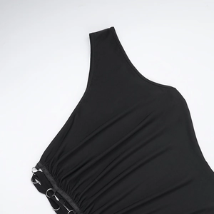Detail of black one-shoulder dress showing elegant ruching and metallic ring ornament