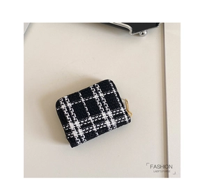 Close-up of black and white tweed lady's small purse with premium golden metal zipper