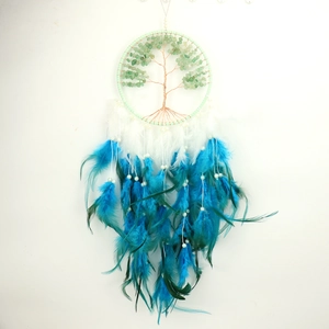Detail of tree of life dreamcatcher with green crystal stones and blue feathers