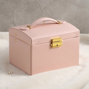 Pink PU leather jewelry box detail featuring golden metal handle and secure lock mechanism