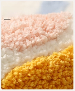 Macro shot of thick flocked bathroom mat fibers showing pink and yellow water absorption texture