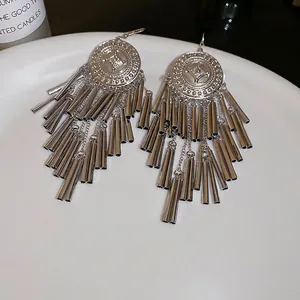 Vintage silver tassel earrings with geometric round hollow charms in a bohemian style