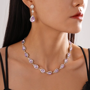 Sparkling silver necklace and earrings set with purple teardrop halo crystals