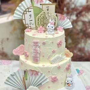 Chinese style double-layer birthday cake with cute rabbit dolls and pink cherry blossoms