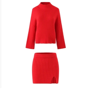 Detail of red knit two-piece set featuring turtleneck sweater and slit skirt texture