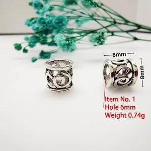 Macro shot of 8mm antique silver hollow pattern barrel beads for DIY jewelry making