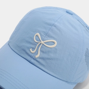 Detail of light blue quick-dry baseball cap with white bow and laser-cut vents
