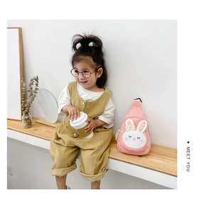 Pink canvas kid chest bag with cute rabbit embroidery and bow detail in use