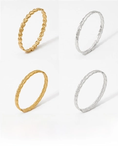 Detailed views of geometric stainless steel rings in gold and silver finish