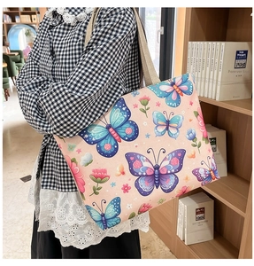 Detail of pink canvas tote bag with floral butterfly print in a cozy library setting
