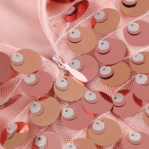 Detail of pink sequins and mesh fabric with high-quality invisible zipper closure