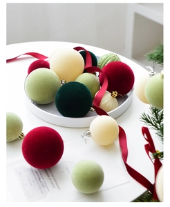 Detailed view of velvet flocked Christmas ball ornaments in festive green and wine red