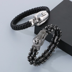 Macro view of woven leather bracelets with silver skull and buckle details for men