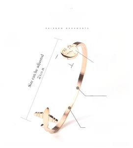 Detail view of adjustable rose gold airplane and globe bangle with dimensions and specs