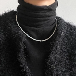 Close-up of minimalist sterling silver white shell rice pearl necklace on a model