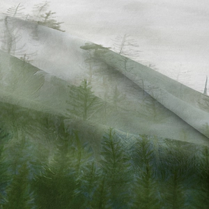 Close-up of translucent bohemian tapestry featuring misty green forest and pine trees
