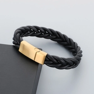 Macro shot of men's braided leather bracelet with matte gold magnetic clasp detail