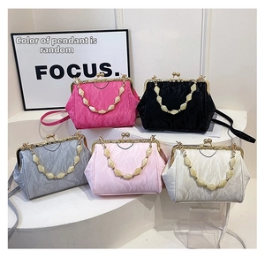Detail of five-color vintage clutch bags with pleated texture and pearl beaded handles