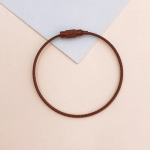 Detailed close-up of brown coated stainless steel wire keychain with screw lock connector