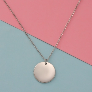 Macro view of a polished stainless steel circular pendant with a fine silver chain