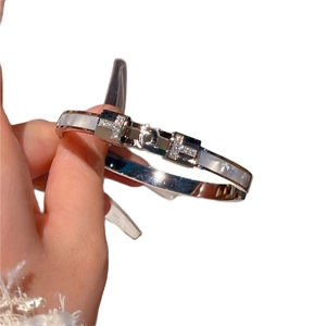 Silver stainless steel H-shaped bangle with mother of pearl inlay and crystal accents