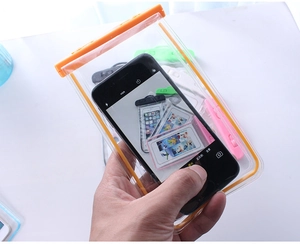 Close-up of clear PVC waterproof phone pouch with orange locking clip and touchscreen view