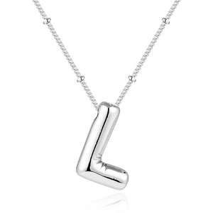 Detail of silver balloon letter L pendant with unique bead chain on white reflective surface