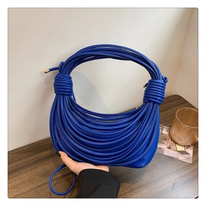 Detail of Klein blue knotted shoulder bag with unique multi-strand soft leather design