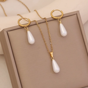 Classic gold jewelry set featuring faux pearl drop necklace and matching earrings