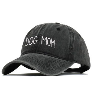 Detail of DOG MOM white embroidery on vintage washed grey cotton baseball cap