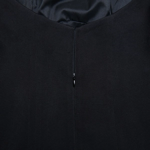 Detail of the high-quality invisible back zipper on a slim-fit black A-line dress