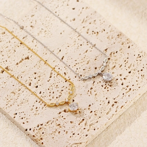 Exquisite S925 silver zircon necklace in gold and silver finishes on stone background