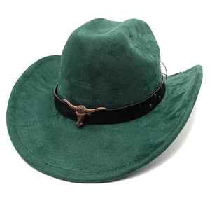 Detail of dark green suede cowboy hat featuring vintage bull head metal ornament and leather strap