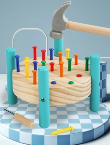 Close-up of wooden pounding bench toy with colorful pegs and tools for kids