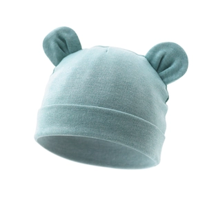 Close-up of light cyan ribbed knit baby hat with cute 3D round ears and soft texture