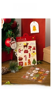 Close-up of 60pcs Christmas stickers set with Santa and reindeer on wooden background