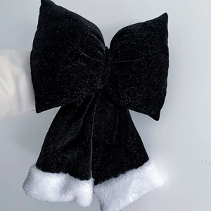 Large black velvet Christmas bow with white faux fur trim and shimmering silver glitter