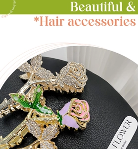 Detail of rose hair claws with rhinestones and enamel petals on a golden metal clip