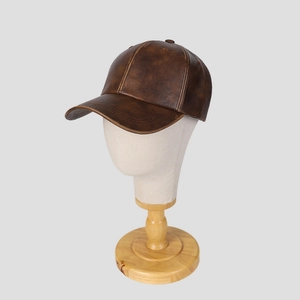 Vintage brown PU leather baseball cap with distressed texture on a display stand