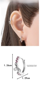 Bow earrings with pink zircon detail showing 1.26cm size and ear fitting view