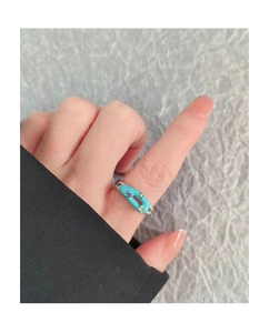 Detail of silver open ring featuring turquoise enamel and sparkling zircon inlay